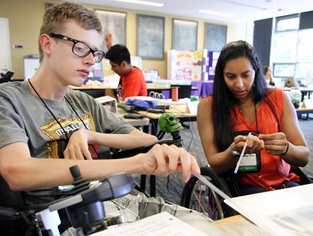 Image of students working together to construct kites.