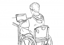 A student in a wheelchair using a laptop.