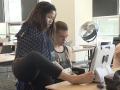 Two students with disabilities use a computer in a classroom.