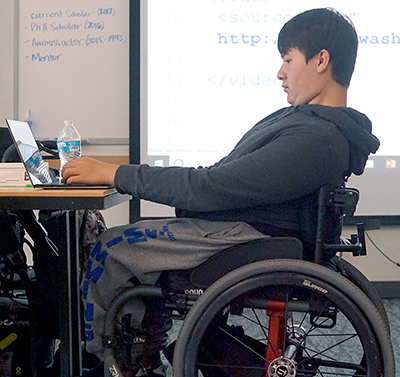 A student codes on his laptop.