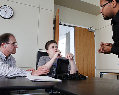 Image of a student communicating with sign language in a computer lab