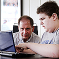 Image of an instructor mentoring a student on a laptop