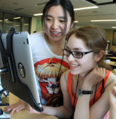 Two students collaborate on a computer project