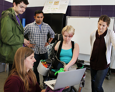 Image of instructors showing a demo to students