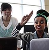 Two students collaborate on a computer project together