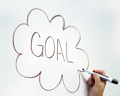 Image of "GOAL" written in a thought bubble on a whiteboard