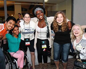 Students of a variety of backgrounds and abilities smile at the camera.