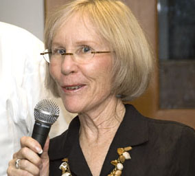 Picture of woman speaking into a microphone.