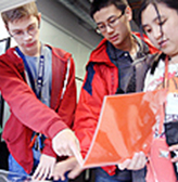 Three students work on an engineering project together