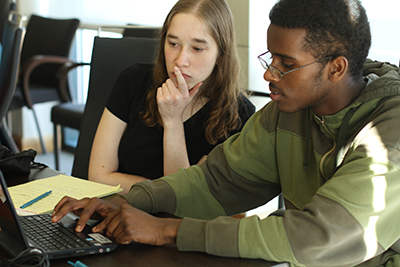 Two people collaborate on computing project