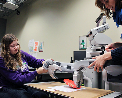 Image of a student participating in a robotics demo