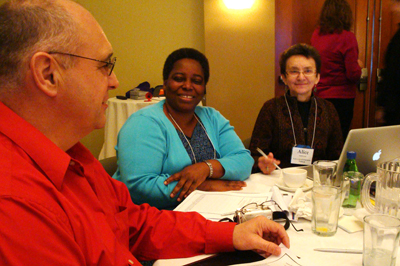 Photo of three faculty members collaborating at a capacity-building institute.