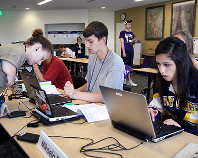 Image of students working in a computer lab on their laptops