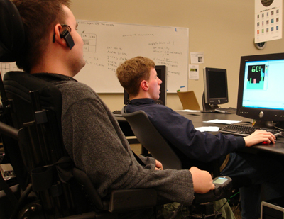 Phase II Scholar Lukas and Ambassador Chris work on a computing puzzle.