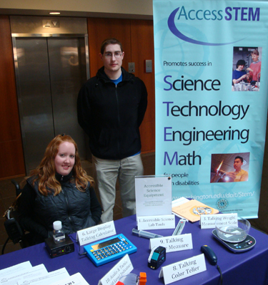 Picture of Scott and Kayla at a display booth with accessible science equipment.